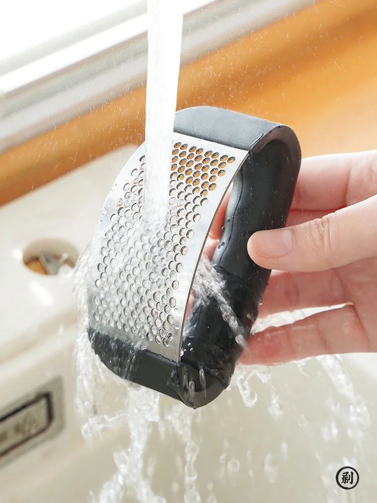 Stainless Steel Garlic Press: Effortless Crushing, Instant Flavor.